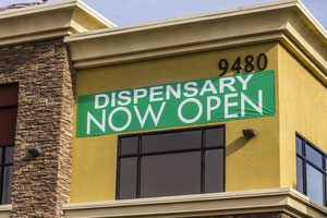 A sign that says dispensary now open
