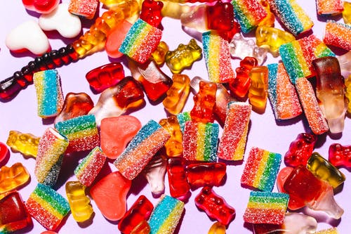 A close up of gummy bears and candy
