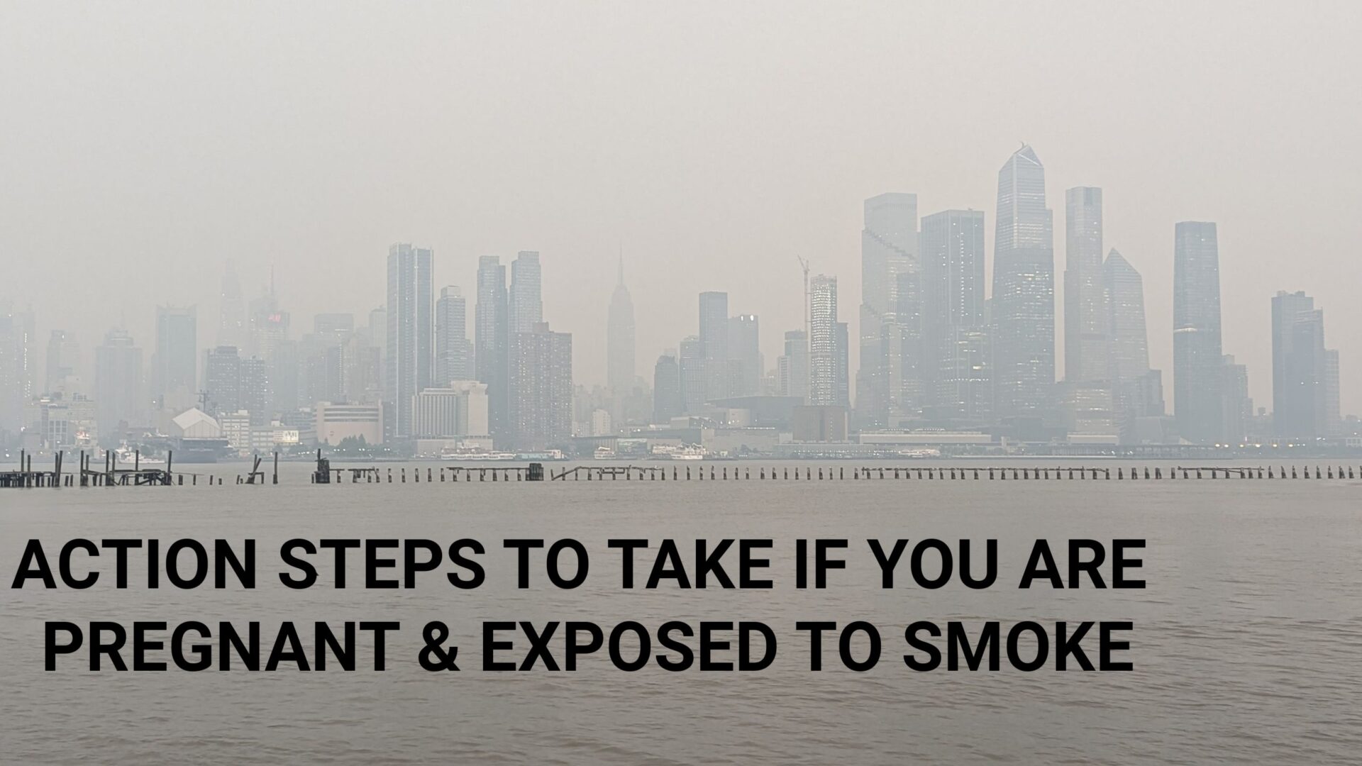 A city skyline with smoke in the background.