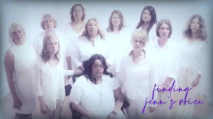 A group of women in white shirts and a purple sign.